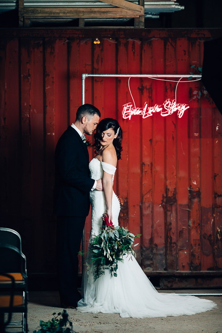 Ceremony Room Neon Sign Backdrop Metal Frame Foliage Edgy Raw Industrial Barn Wedding Ideas Greenery Festoon Lights http://www.two-d.co.uk/