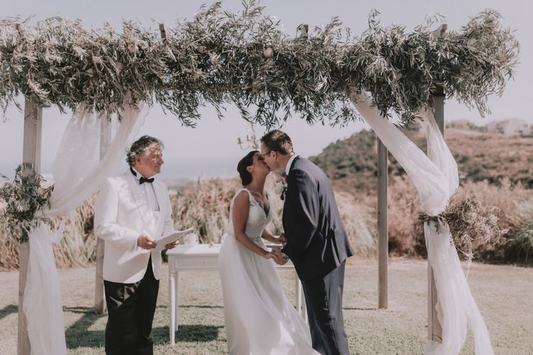 Outdoor Fields Garden Villa Italy Rustic Natural Vineyard Orchard Bride Groom Ceremony Aisle White Greenery Floral Arch Kiss | Sage Green Mediterranean Destination Wedding Spain https://www.kinoortega.com/