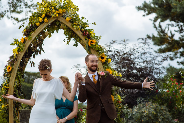 DIY Ceremony Bride Groom Yellow Wildflower Floral Arch Seasonal Alternative Hippy Farm Field Garden Wedding | Homegrown Community Eclectic Rural Yorkshire Wedding https://toastofleeds.co.uk/
