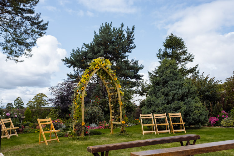 DIY Ceremony Flower Arch Yellow Orange Seasonal Alternative Hippy Farm Field Garden Wedding | Homegrown Community Eclectic Rural Yorkshire Wedding https://toastofleeds.co.uk/