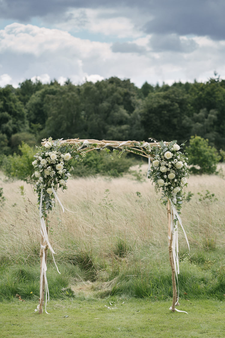 Ceremony Arch Greenery White Cream Flowers Floral Wood Relaxed Bohemian Summer Meadow Wedding https://karibellamy.com/