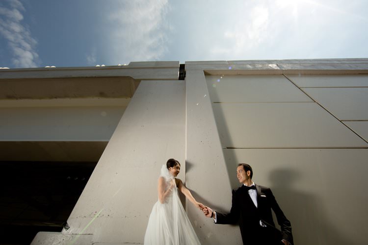 Bride Groom Photo Bridge Hangar White Building | Black Tie Carnival Wedding Hot Air Balloon http://www.makingthemoment.com/