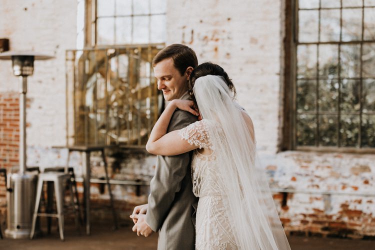 City Urban Georgia Engine Room Exposed Bricks Bride Groom Embrace First Look | Bohemian Industrial Oxblood Wedding https://www.lunaleephotos.com/