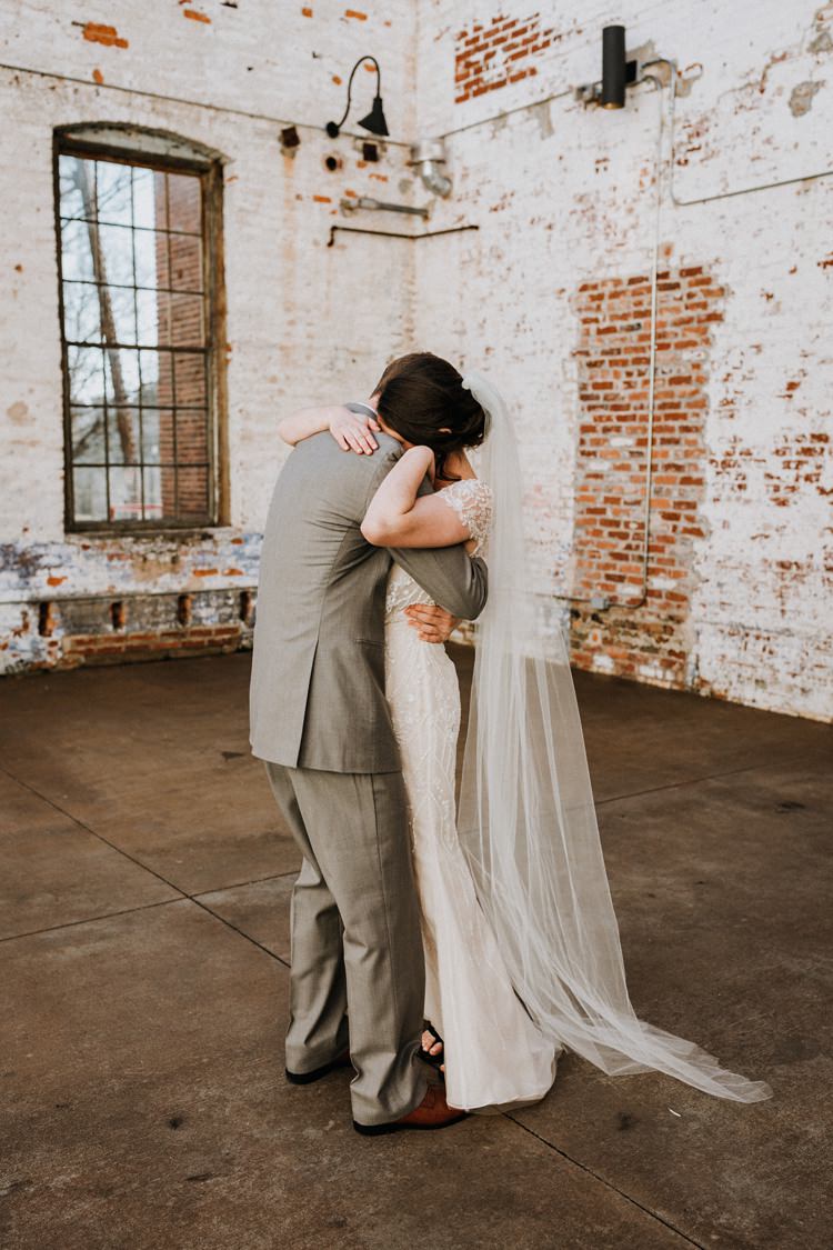 City Urban Georgia Engine Room Exposed Bricks Bride Groom Embrace First Look | Bohemian Industrial Oxblood Wedding https://www.lunaleephotos.com/