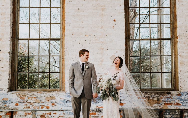 City Urban Georgia Engine Room Exposed Bricks Bride Groom Embrace First Look Green White Bouquet | Bohemian Industrial Oxblood Wedding https://www.lunaleephotos.com/