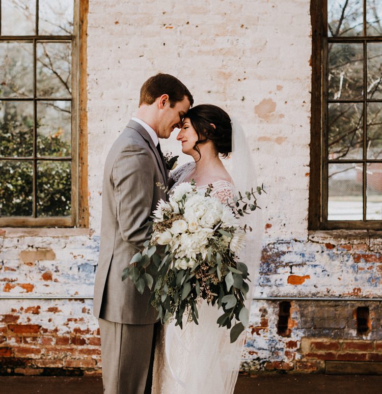 City Urban Georgia Engine Room Exposed Bricks Bride Groom Embrace First Look Green White Bouquet | Bohemian Industrial Oxblood Wedding https://www.lunaleephotos.com/