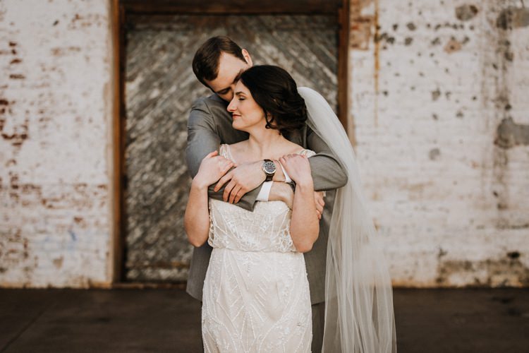 City Urban Georgia Engine Room Exposed Bricks Bride Groom Embrace First Look | Bohemian Industrial Oxblood Wedding https://www.lunaleephotos.com/