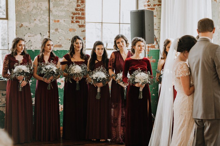 City Urban Georgia Engine Room Exposed Bricks Ceremony Aisle Bride Greenery White Bouquet Burgundy Bridesmaids | Bohemian Industrial Oxblood Wedding https://www.lunaleephotos.com/