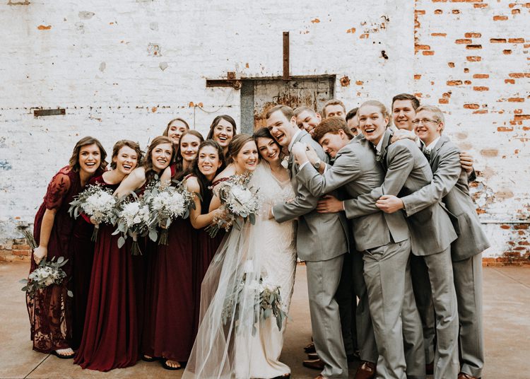 City Urban Georgia Engine Room Exposed Bricks Bridesmaids Groomsmen Bride Groom Hug | Bohemian Industrial Oxblood Wedding https://www.lunaleephotos.com/
