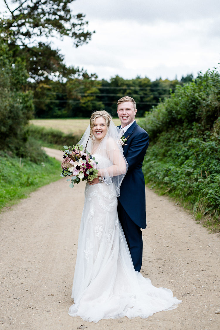 Bride Bridal Lace Strapless Dress Tulle Veil Bouquet Multicoloured Pheasant Feather Groom Blue Tails Waistcoat Three Piece Suit Autumn Countryside Family Farm Wedding Dorset http://www.lydiastampsphotography.com/