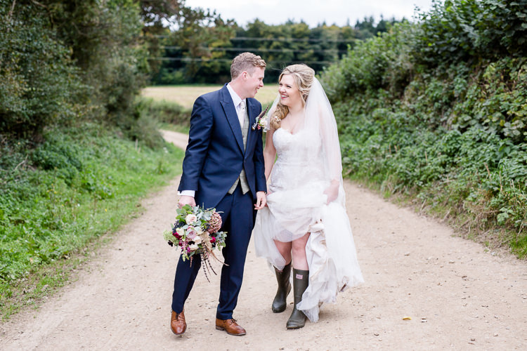 Bride Bridal Lace Strapless Dress Tulle Veil Bouquet Multicoloured Pheasant Feather Groom Blue Tails Waistcoat Three Piece Suit Wellies Autumn Countryside Family Farm Wedding Dorset http://www.lydiastampsphotography.com/