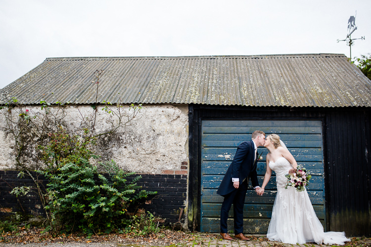 Couples Portrait Bride Bridal Lace Strapless Dress Tulle Veil Bouquet Multicoloured Pheasant Feather Groom Blue Tails Waistcoat Three Piece Suit Autumn Countryside Family Farm Wedding Dorset http://www.lydiastampsphotography.com/