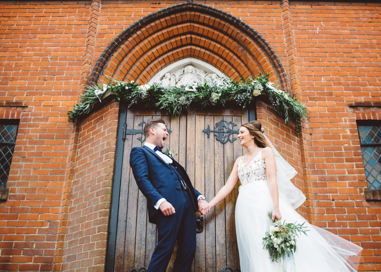 Bride Bridal Hayley Paige Dress Gown Tulle Princess Tuxedo Groom Waistcoat Navy Bow Tie Bouquet Ribbon Church Doorway Greenery Runner Cool Stylish Windy Coastal Wedding East Quay Lobster Shack Whitstable http://holliecarlinphotography.com