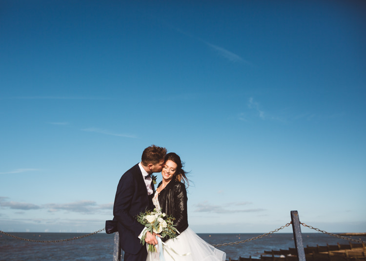 Bride Bridal Hayley Paige Dress Gown Tulle Princess Tuxedo Groom Waistcoat Navy Bow Tie Bouquet Ribbon Leather Jacket Cool Stylish Windy Coastal Wedding East Quay Lobster Shack Whitstable http://holliecarlinphotography.com/