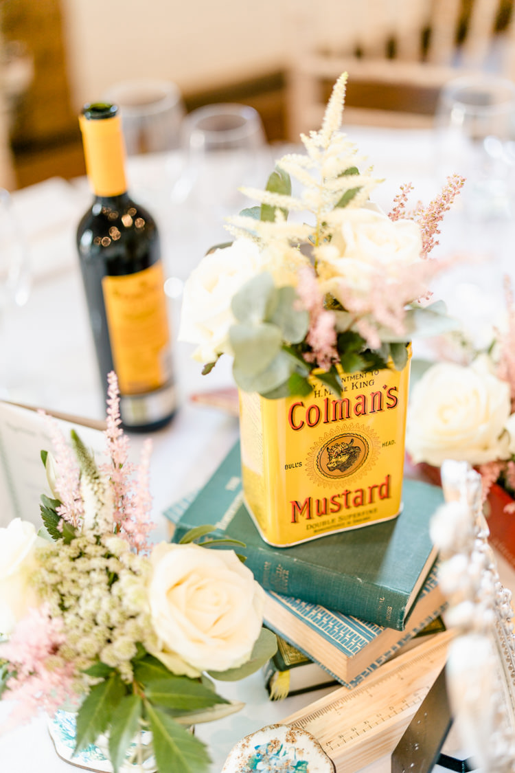 Table Centre Vintage Books Mustard Tin Flowers Rose Eucalyptus Nostalgic Honest British Loseley Park Wedding Surrey https://www.johnbarwoodphotography.co.uk/