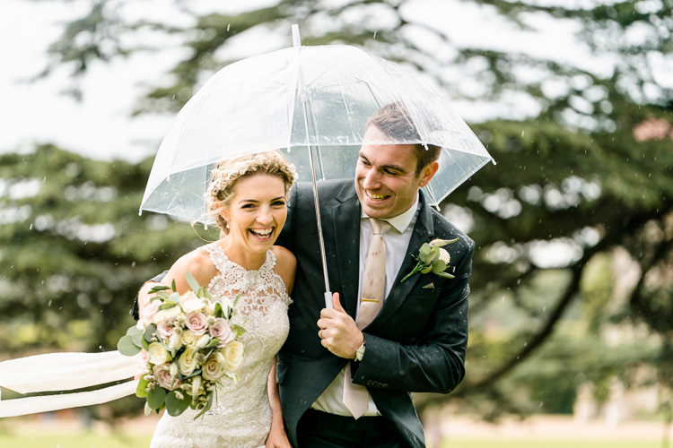 Lace Keyhole Neck Fitted Pronovias Dress Gown Bride Bridal Faux Flower Crown Veil Bouquet Ribbon Rain Clear Umbrella Groom Suit Reiss Bottle Green Nostalgic Honest British Loseley Park Wedding Surrey https://www.johnbarwoodphotography.co.uk/