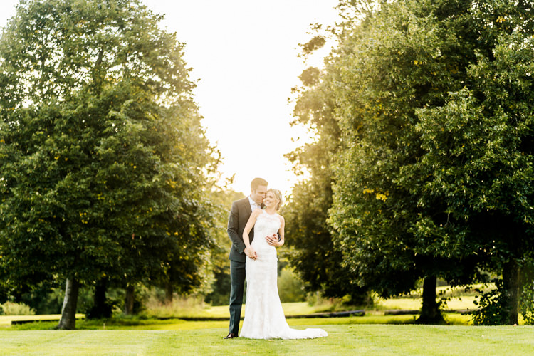 Lace Keyhole Neck Fitted Pronovias Dress Gown Bride Bridal Faux Flower Crown Veil Bouquet Ribbon Reiss Groom Suit Bottle Green Nostalgic Honest British Loseley Park Wedding Surrey https://www.johnbarwoodphotography.co.uk/