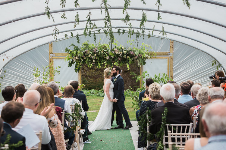 Bride Bridal Gown Dress Backless Simple Cap Sleeve Lace Train Flower Greenery Crown Blue Suit Hackett Groom Hanging Foliage Greenery Spring Floral Polytunnel Sunny Wedding Colstoun House Scotland http://solenphotography.co.uk/