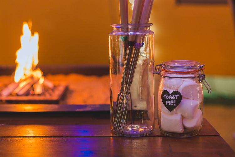 Marshmallows Fire Pit Toasting Colourful Outdoor Tipi Farm Wedding https://kirstymackenziephotography.co.uk/