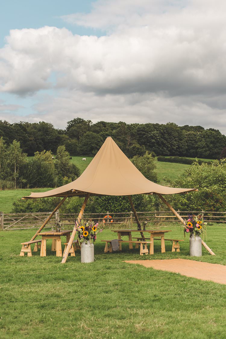 Mini Tipi Seating Area Milk Churns Sunflowers Colourful Outdoor Tipi Farm Wedding https://kirstymackenziephotography.co.uk/
