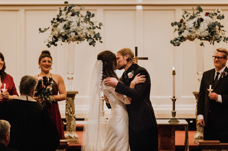Warehouse Rustic Chic Refined Church Aisle Ceremony Groom Bride Kiss | Boho Industrial Winter Wedding Lunalee Photography