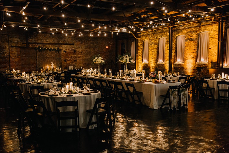 Warehouse Rustic Chic Refined Atlanta King Plow Wedding Table Black Chairs White Flowers Festoon Lights | Boho Industrial Winter Wedding Lunalee Photography