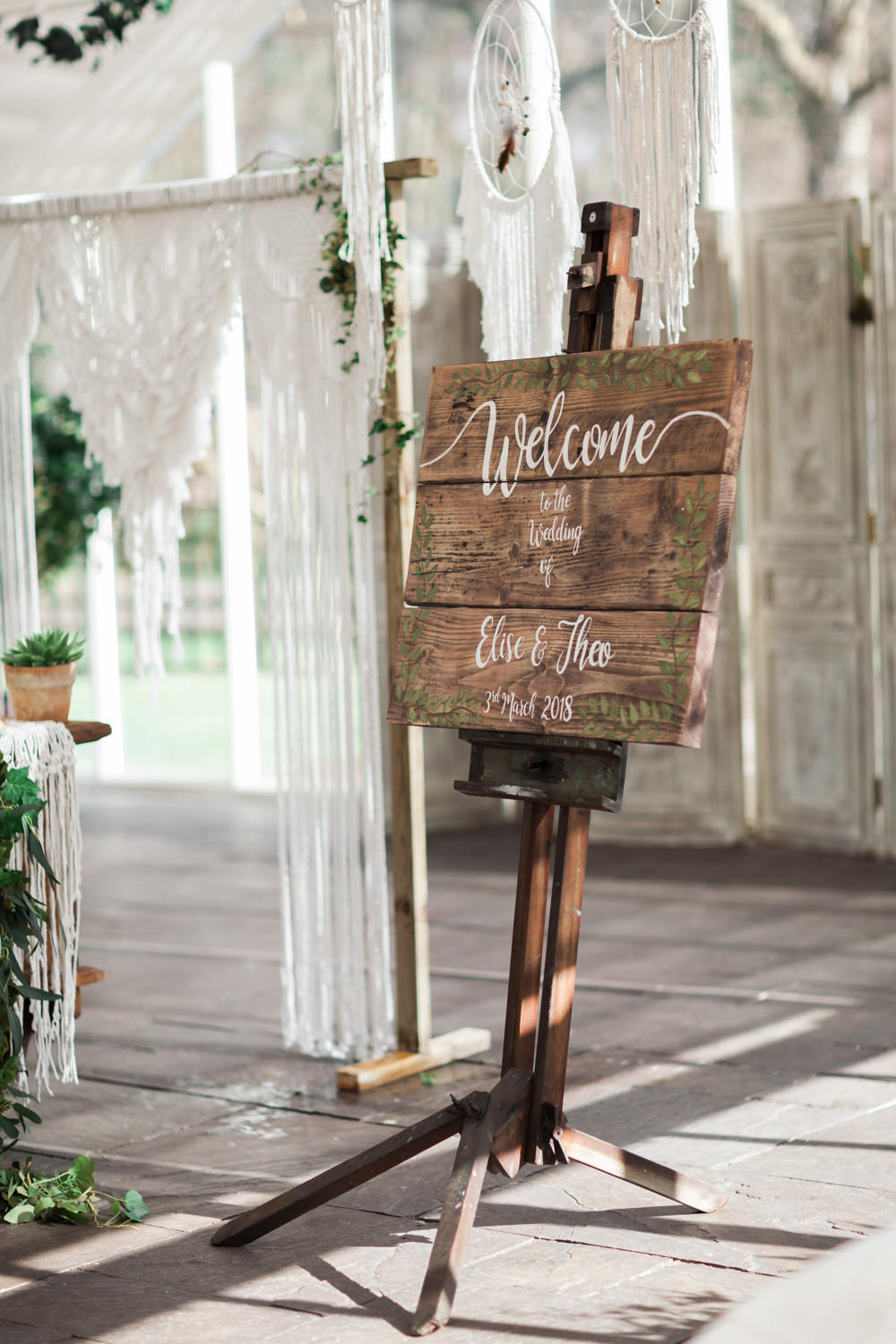 Wooden Rustic Welcome Sign Calligraphy Painted Botanical Macrame Glass House Wedding Ideas Jo Bradbury Photography