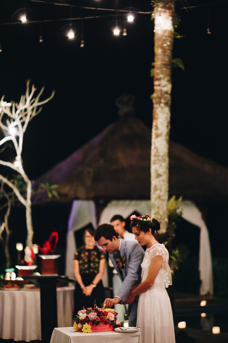 Outdoor Destination Luxury Adventure Ubud Colorful Tropical Flower Crown Bride Groom Cake Cutting | Whimsical Exotic Tropical Jungle Wedding Bali http://www.cecilephotographybali.com/