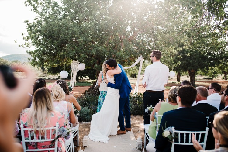 Spain Sun Outdoor Tropical Mediterranean Garden Villa Outdoor Ceremony Hugs Kiss | Ibiza Destination Wedding Amy Faith Photography