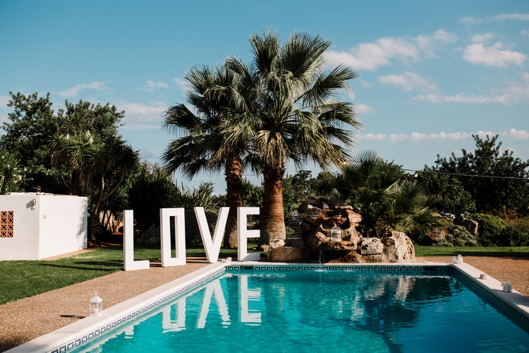 Spain Sun Outdoor Tropical Mediterranean Garden Villa Outdoor Pool Party Giant Love Letters | Ibiza Destination Wedding Amy Faith Photography
