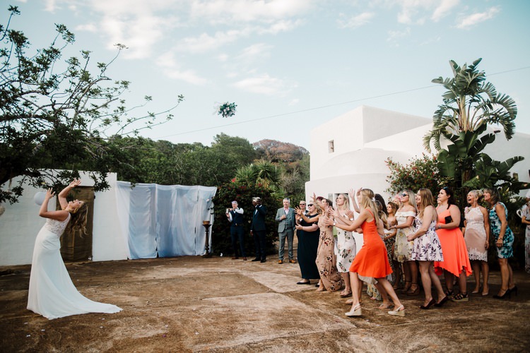 Spain Sun Outdoor Tropical Mediterranean Garden Villa Bride Bouquet Toss | Ibiza Destination Wedding Amy Faith Photography