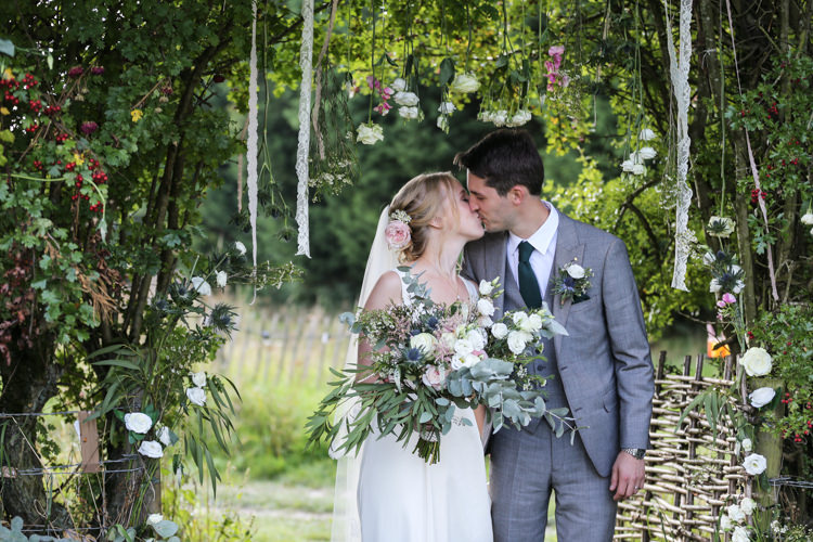 Bride Bridal V Neck Charlie Brear Dress Gown Ted Baker Groom Waistcoat Three Piece Grey Green Tie Loose Wild Bouquet Lace Ribbons Floral Installation Hanging Manor Farm Wedding Hampshire Luke Doyle Photography