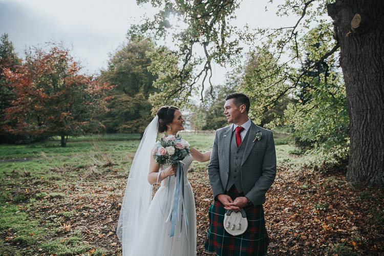 Bride Bridal Dress Gown Lace Sweetheart Neckline Short Sleeve Full Skirt Kilt Groom Tartan Waistcoat Red Green Bouquet Ribbons First Look The Byre at Inchyra Wedding Jen Owens Images