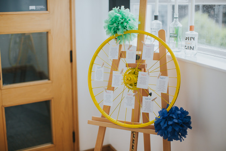Bike Wheel Table Plan Easel Paper Pom Poms The Workstation Cinema Colourful Wedding Bloom Weddings