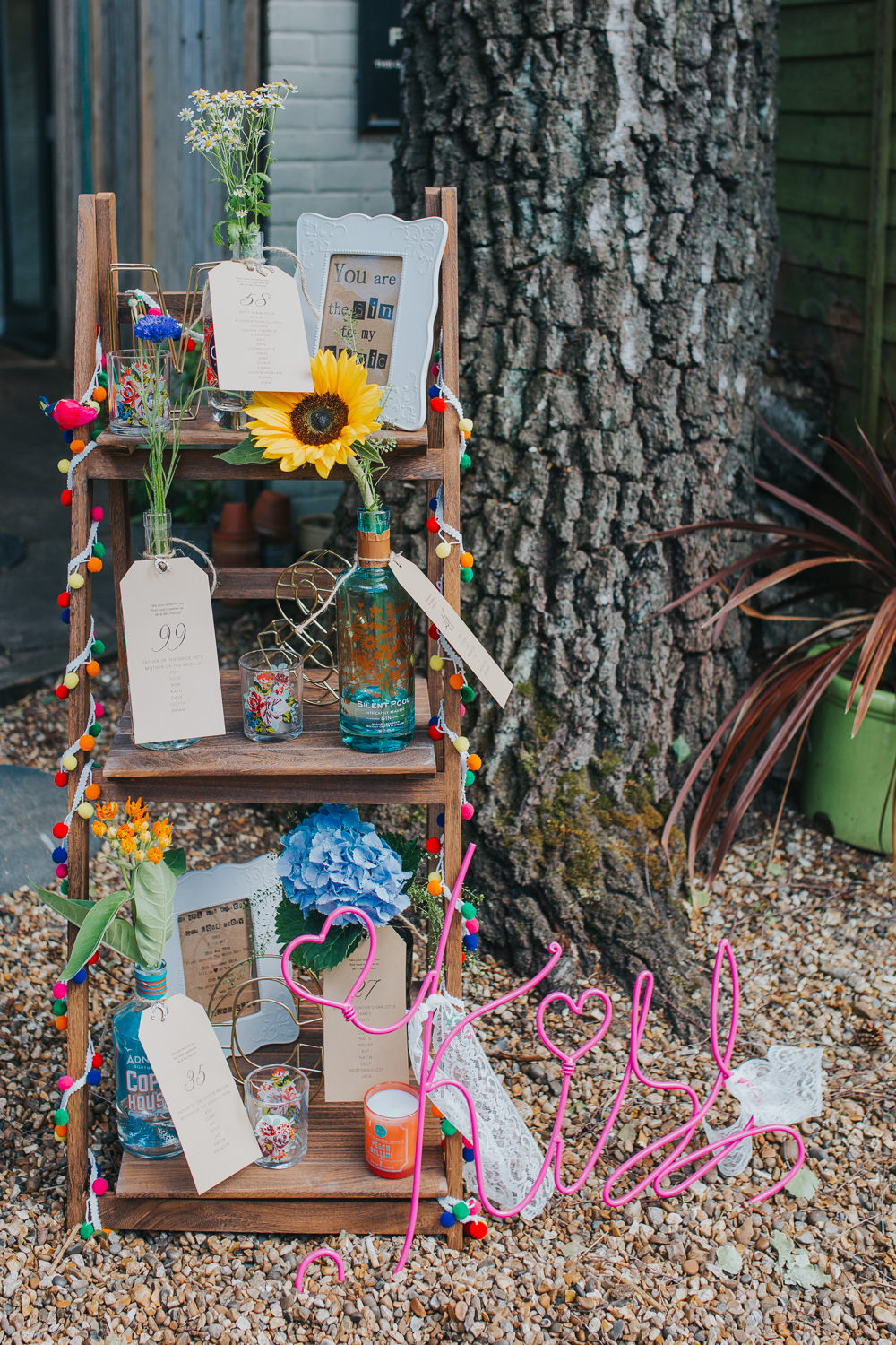 Gin Bottle Seating Plan Table Chart Flowers Wooden Ladder Colourful Bright Summer Pub Wedding Charlotte Razzell Photography