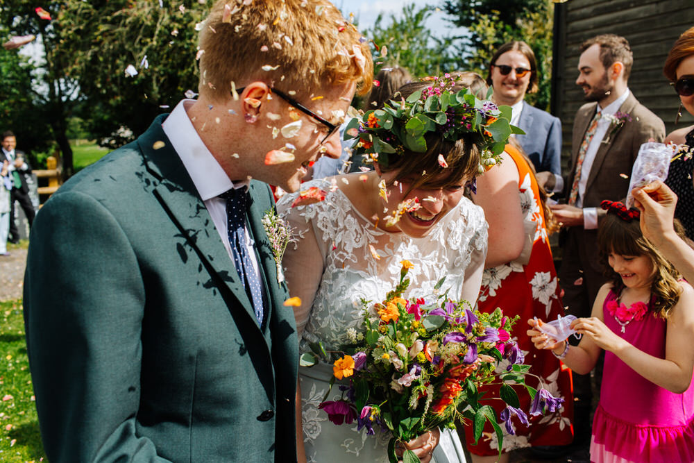 Bride Bridal Tea Length Sleeved Dress Flower Crown Multicoloured Bouquet Flower Crown Groom Bottle Green Suit Three Piece Confetti Secret Barn Sussex Wedding Rainbow Colourful Yvonne Lishman Photography