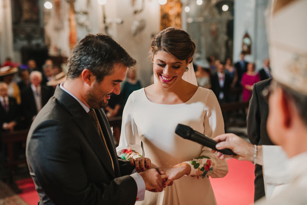 Outdoor Seville Destination Baroque Church Aisle Ceremony Bride Groom Rings | Colorful and Heartfelt Wedding in Spain Boda&Films