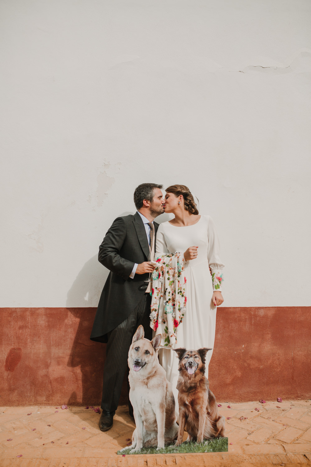 Outdoor Seville Destination Villa Hacienda Bride Groom Kiss Colorful Floral Dress Dog Cutout | Colorful and Heartfelt Wedding in Spain Boda&Films