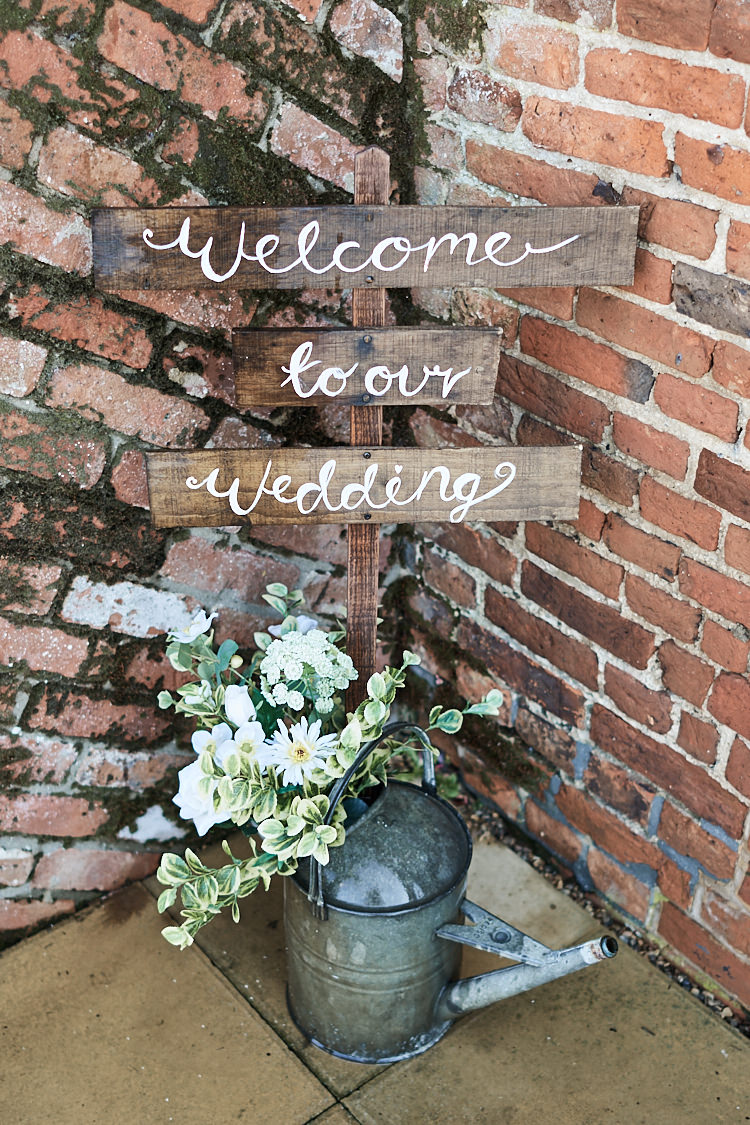 Rustic Wooden Sign Post Welcome Watering Can Flowers Wood Farm Barn Wedding Suffolk Faye Amare Photography