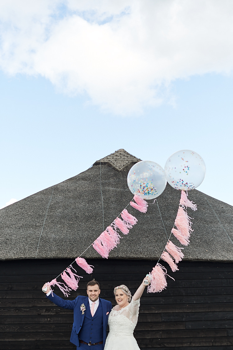 Bride Bridal A Line Sleeved Dress Gown Lace Off the Shoulder French Connection Groom Blue Waistcoat Three Piece Pink Tie Tasseled Confetti Balloons Wood Farm Barn Wedding Suffolk Faye Amare Photography