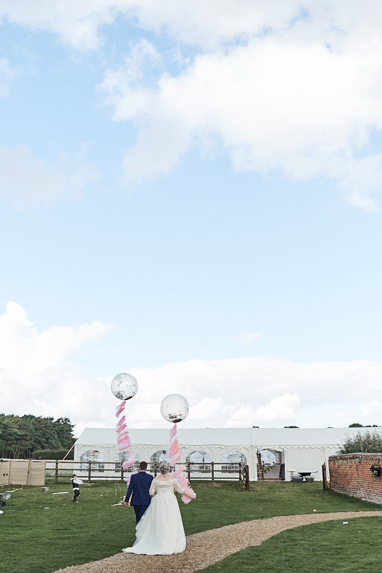 Bride Bridal A Line Sleeved Dress Gown Lace Off the Shoulder French Connection Groom Blue Waistcoat Three Piece Pink Tie Tasseled Confetti Balloons Wood Farm Barn Wedding Suffolk Faye Amare Photography