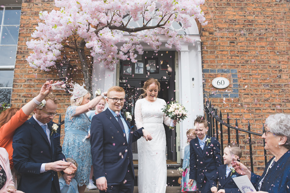 Bride Bridal Lace Long Sleeve Savannah Miller Dress Gown Navy Hugo Boss Groom Pink Rose Bouquet Blossom Tree Confetti Real Petals 60 Hope Street Wedding Lisa Howard Photography