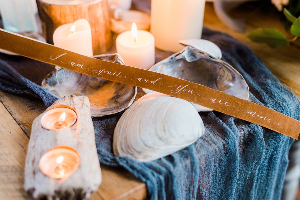 Nature Inspired Styled Shoot Seashell Tablescape Candles Grey Blue Gold Crystal Glasses Silk Ribbon Driftwood | Ocean Wedding Ideas Industrial Rachel Watkinson Photography
