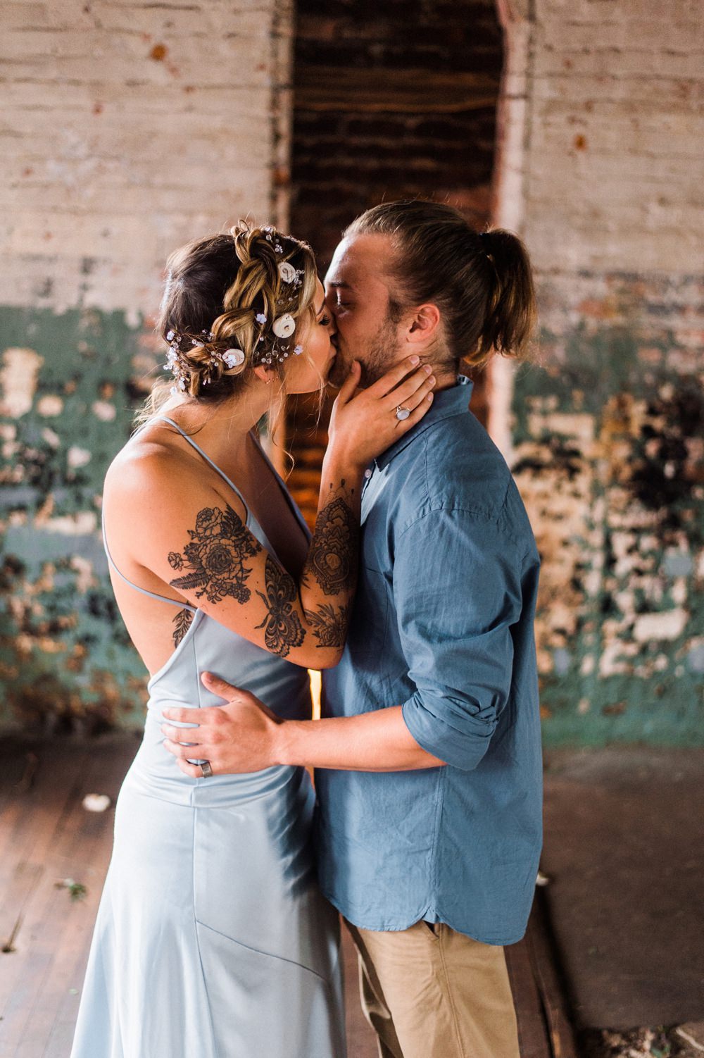 Nature Inspired Styled Shoot Seashell Headpiece Updo Tattooed Bride Blue Dress Casual Groom Blue Shirt Pastel Kiss | Ocean Wedding Ideas Industrial Rachel Watkinson Photography