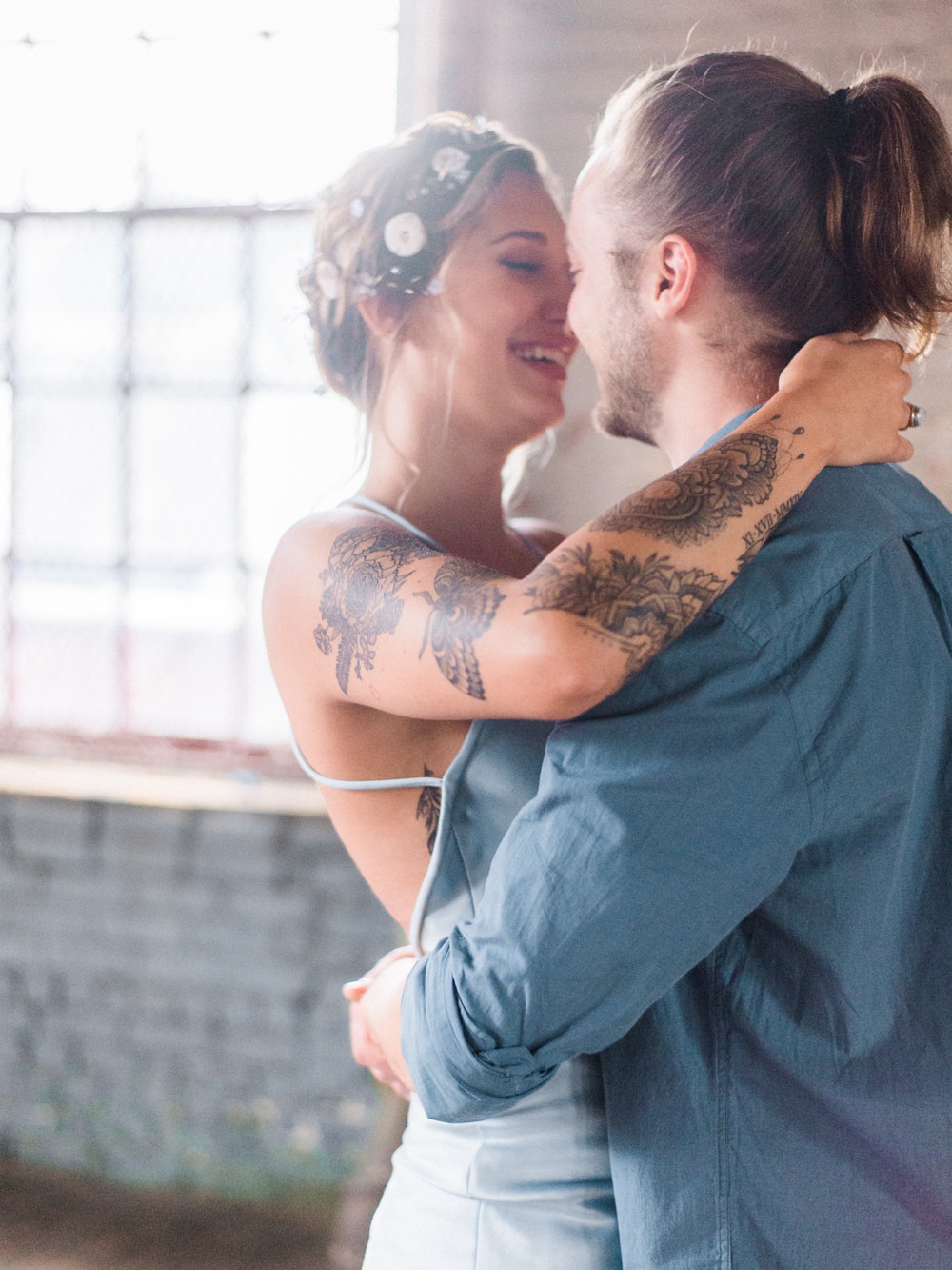 Nature Inspired Styled Shoot Seashell Headpiece Updo Tattooed Bride Blue Dress Casual Groom Blue Shirt Pastel Kiss | Ocean Wedding Ideas Industrial Rachel Watkinson Photography