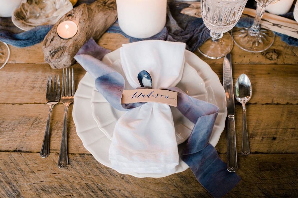 Nature Inspired Styled Shoot Seashell Tablescape Grey Blue Silk Ribbon Calligraphy Place Card Oyster Candles Driftwood | Ocean Wedding Ideas Industrial Rachel Watkinson Photography