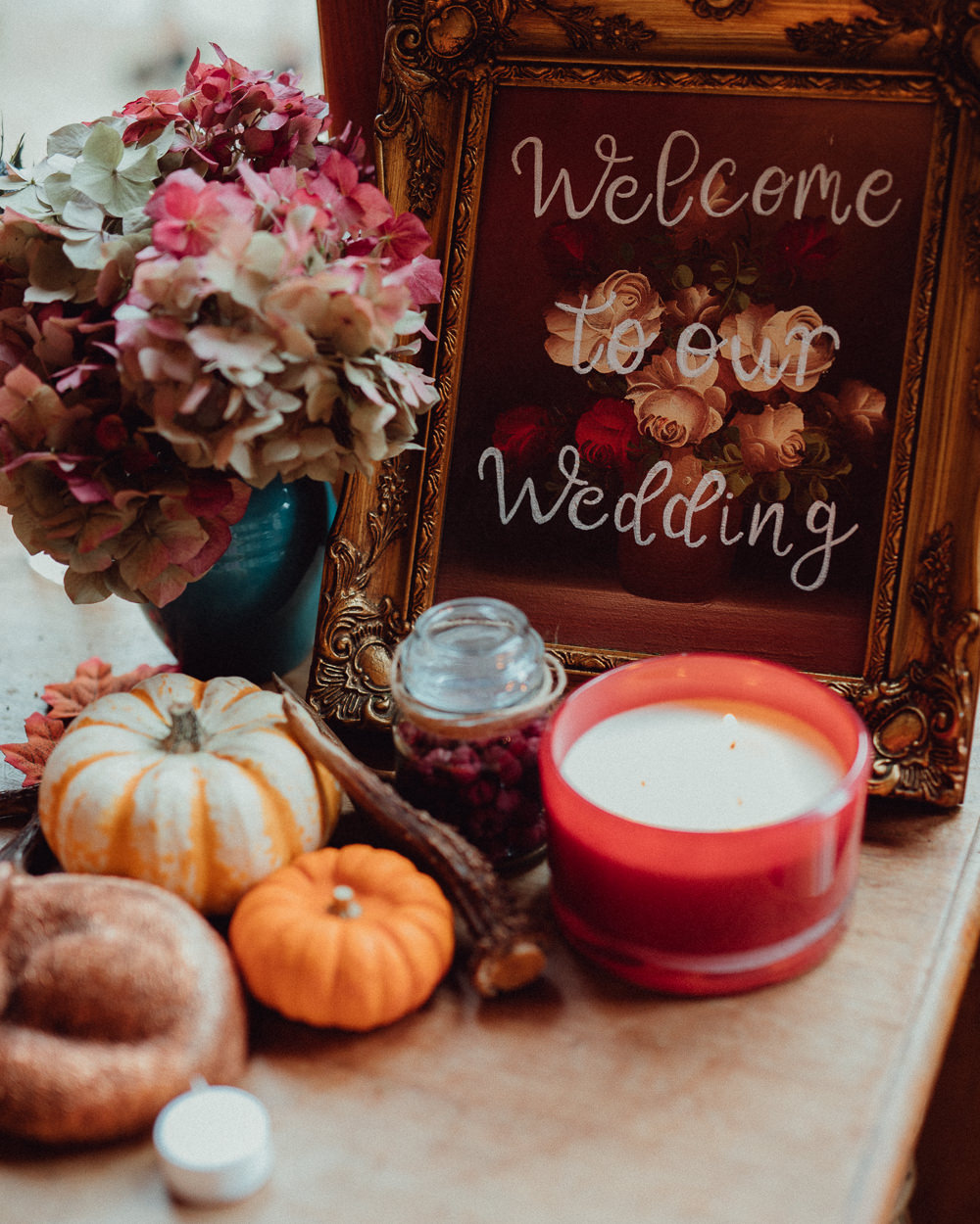 Floral Calligraphy Welcome Sign Candles Pumpkins Autumn Decor Oxleaze Barn Wedding Emily and Steve Photography