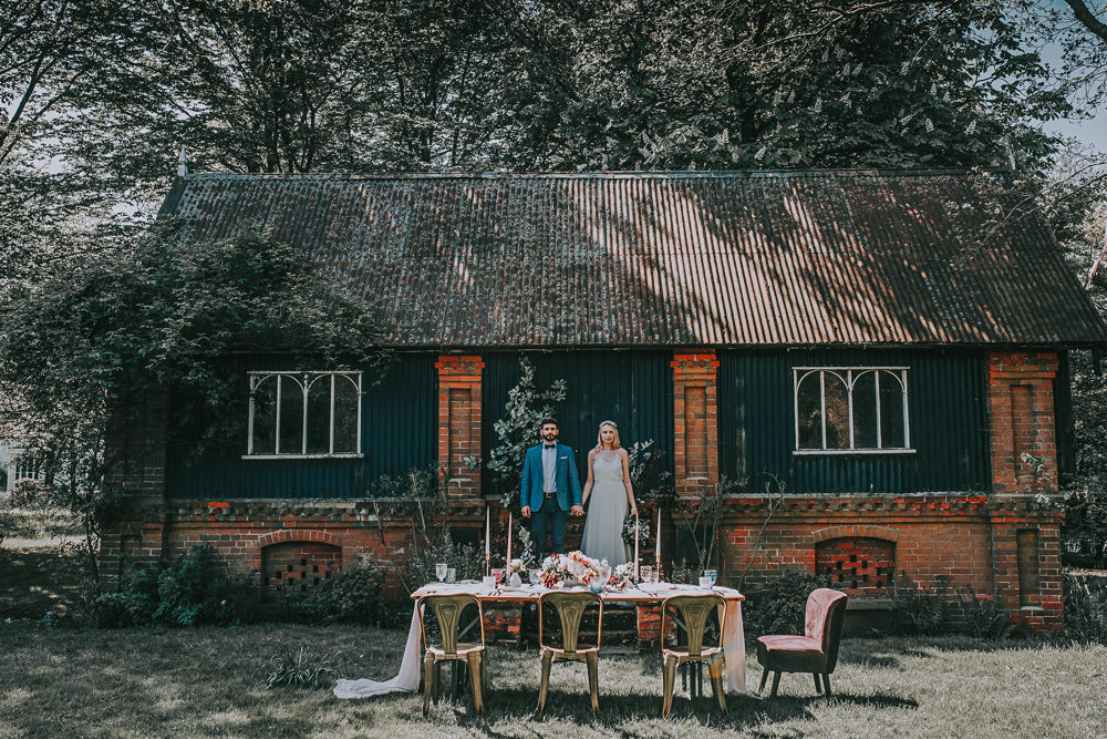 Secret Dresshouse Ethereal Bride Bridal Gown Blue Linen Jacket Bow Tie Groom Leaf Foliage Flower Florals Tablescape Gold Bistro Velvet Chair River Romance Wedding Ideas Mindy Coe Photography