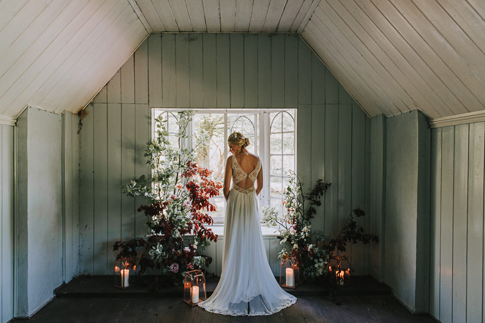 Secret Dresshouse Ethereal Bride Bridal Gown Storm Hurricane Candles Lanterns Leaf Foliage Flower Florals River Romance Wedding Ideas Mindy Coe Photography