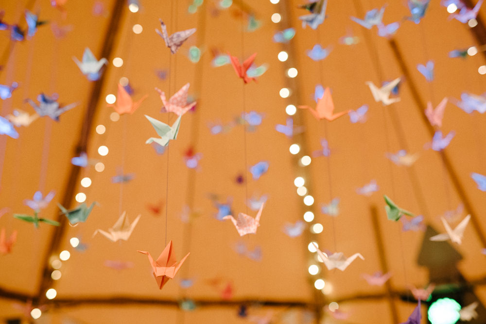 Outdoor Farm Field Marquee Blue Yellow Wedding Suspended Origami Cranes | Rustic and Relaxed Spring Tipi Wedding Inbetween Days Photography